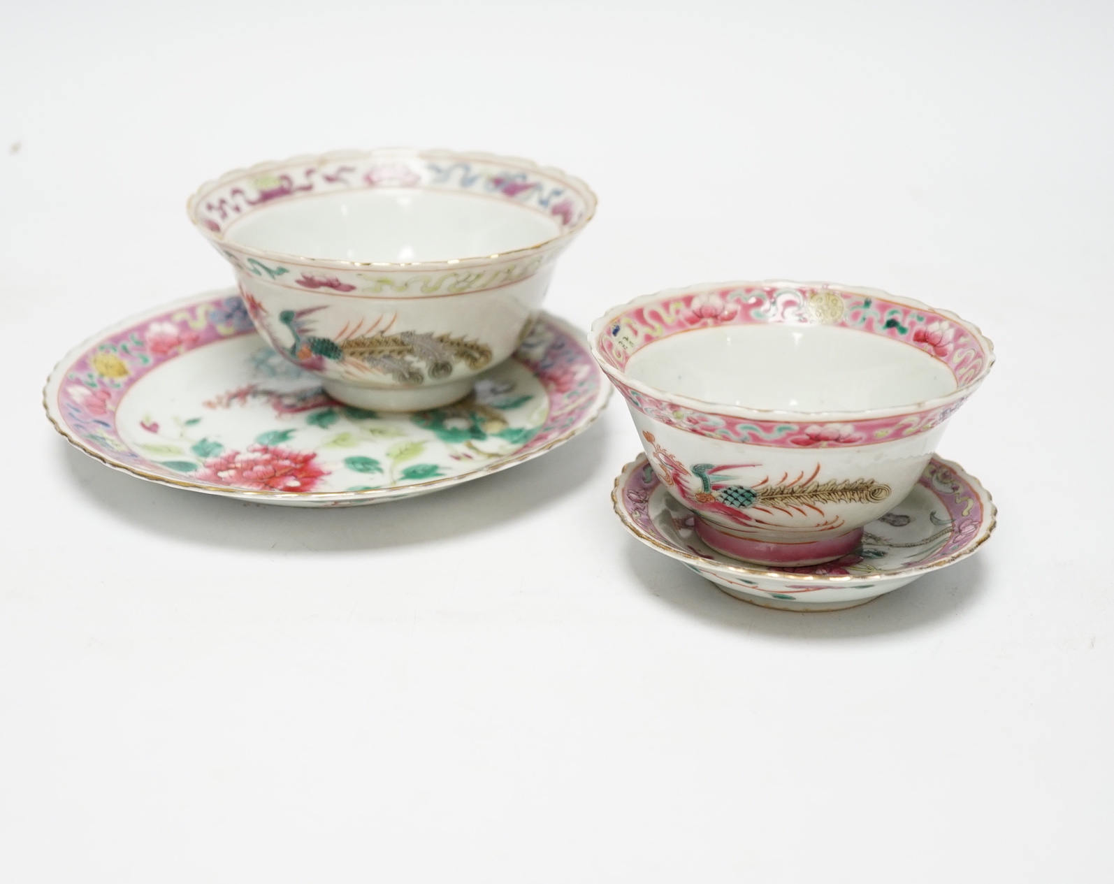 Two Chinese Straits Nonya ware famille rose tea bowls, larger 11cm diameter, and two saucer dishes, Guangxu period